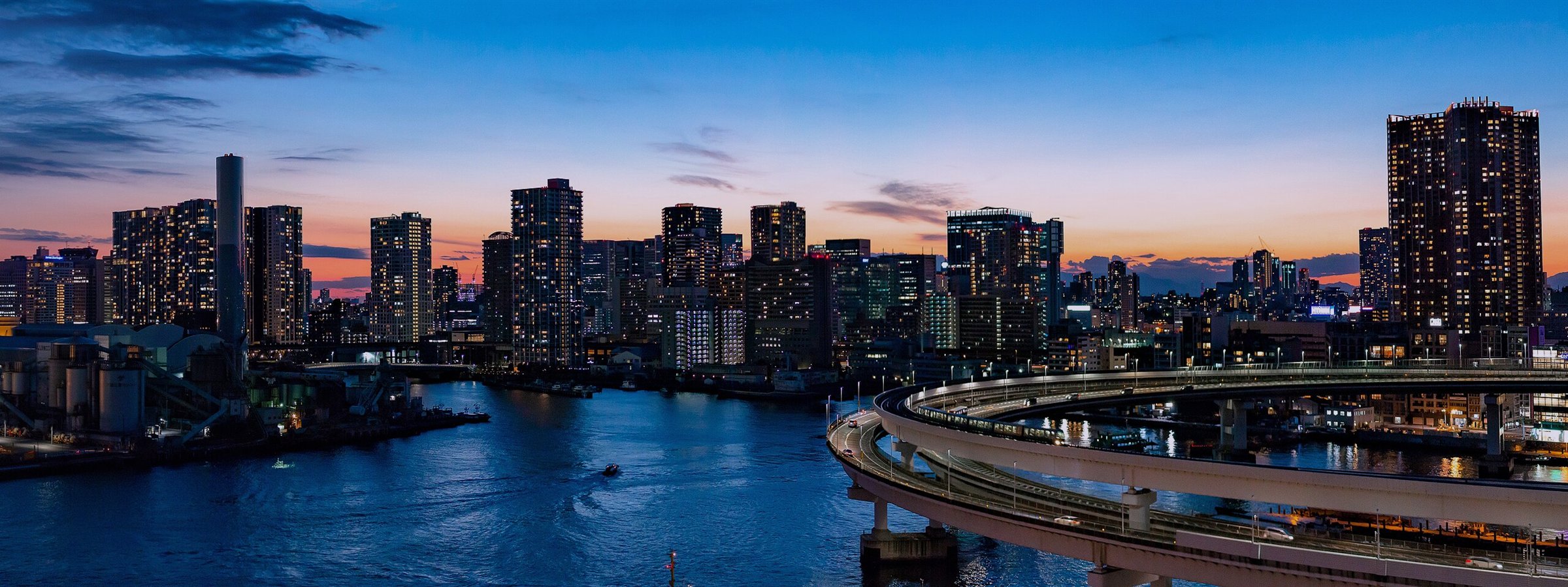 The Tokyo skyline at night, seen across the water