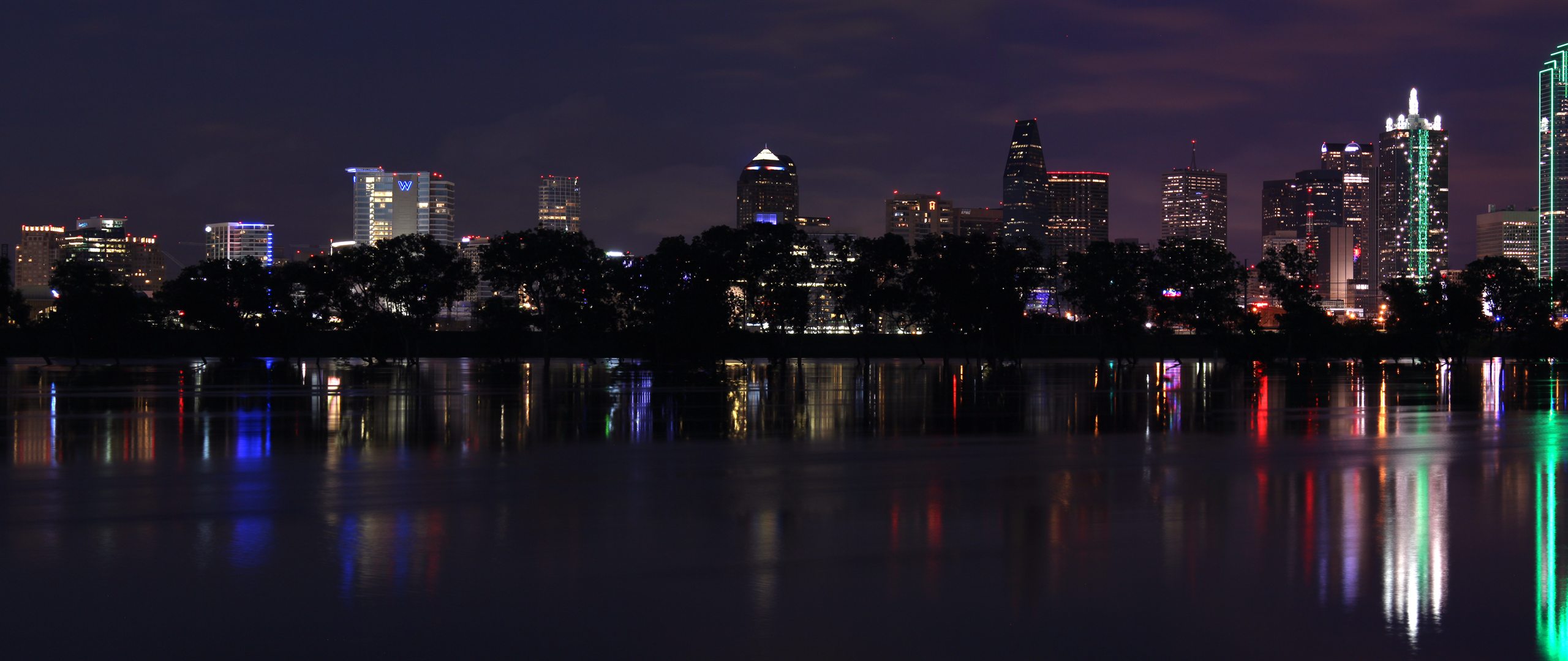 The Dallas skyline at night, reflected in the Trinity River